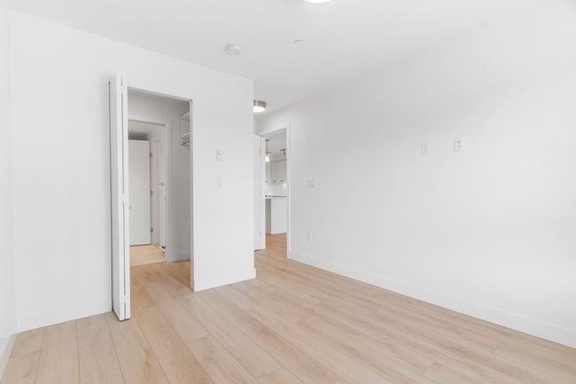 Unfurnished bedroom with light wood-style flooring and baseboards | Image 13