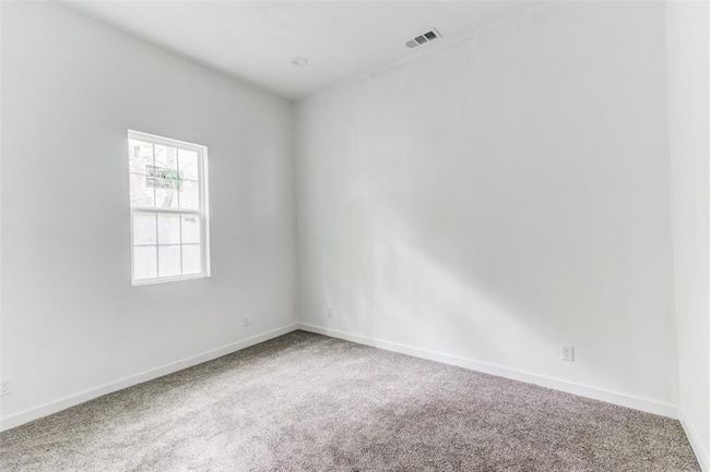 Unfurnished living room featuring a towering ceiling, a healthy amount of sunlight, and hardwood / wood-style floors | Image 7