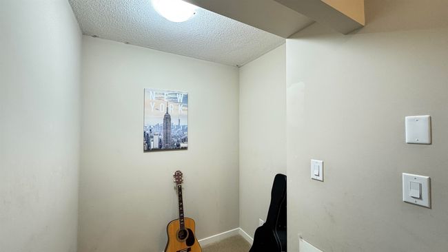 Clothes washing area featuring a textured ceiling | Image 14
