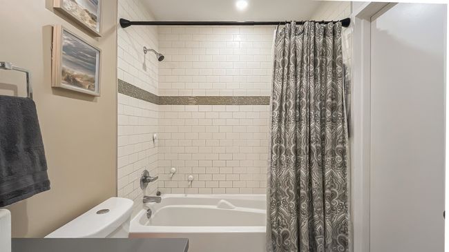 Bathroom featuring shower / bathtub combination with curtain and toilet | Image 17