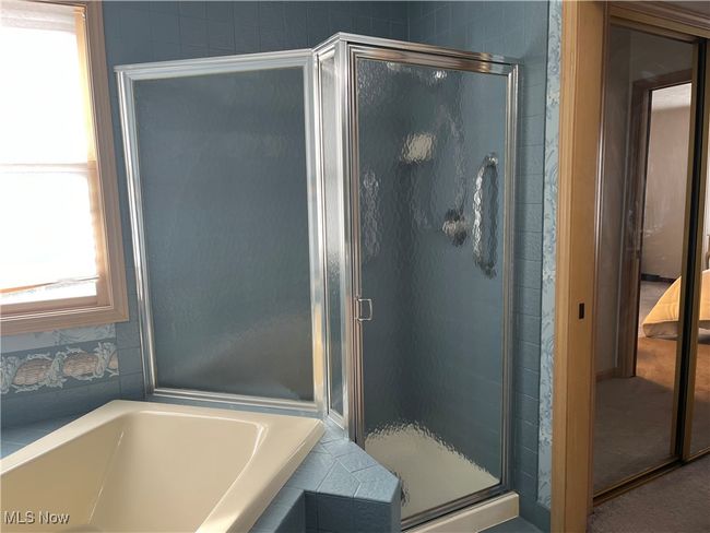 Bathroom featuring separate shower and soaking tub | Image 24