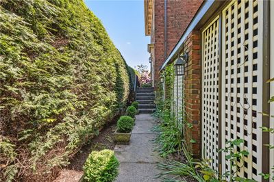 Entry through the front gate and walk to the side entrance, which is now the front door. | Image 3