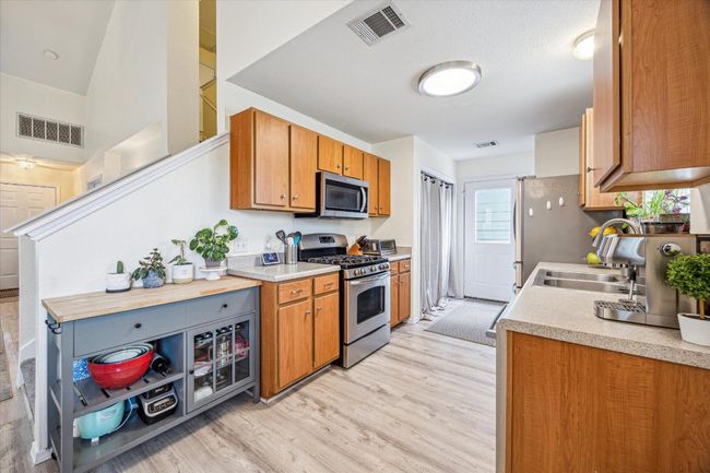 Door at end of kitchen leads to back patio and garage | Image 7