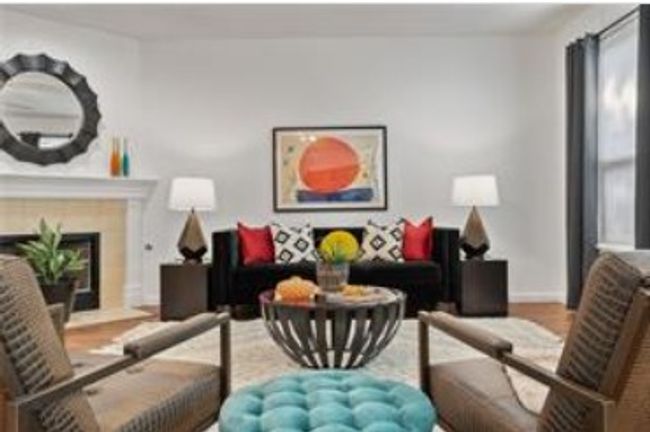 Living room featuring baseboards, wood finished floors, and a fireplace | Image 4