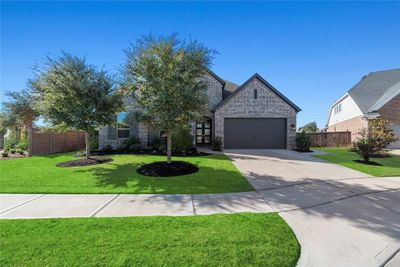 Mature trees, beautiful brick exterior and striking curb appeal combine to create a welcoming atmosphere. | Image 2