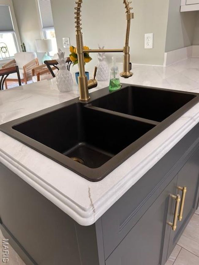 Kitchen view of light stone countertops and gray cabinets | Image 12