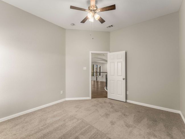 Spare room featuring visible vents, ceiling fan, baseboards, and carpet | Image 30