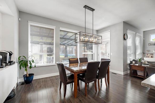 Dining space featuring dark wood finished floors and baseboards | Image 13