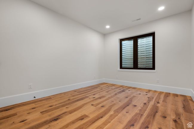 Empty room featuring wood finished floors and recessed lighting | Image 63