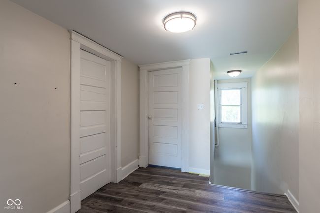 hallway featuring baseboards and dark wood finished floors | Image 34