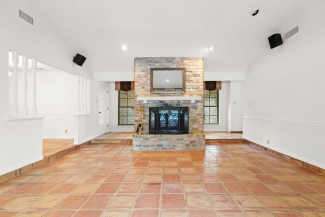 Unfurnished living room with a brick fireplace and recessed lighting | Image 12