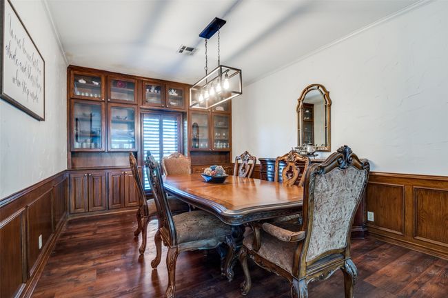 Dining room with handsome wood wainscoted wall, crown molding | Image 11