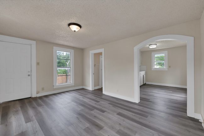 Studio apartment with full kitchen & bathroom with arched doorways, and vinyl wood like floors | Image 32