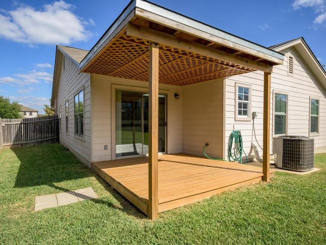 Back of house, wooden deck with a fenced backyard. | Image 26