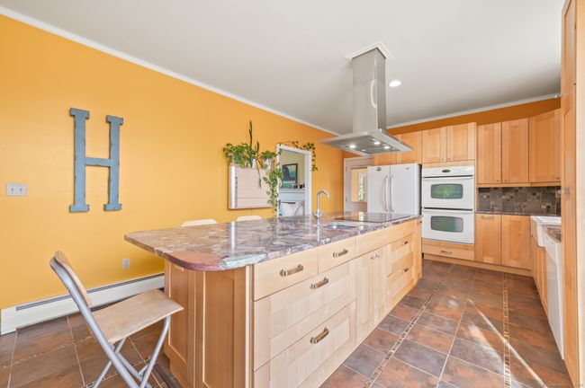 with large island with a stone countertop | Image 21