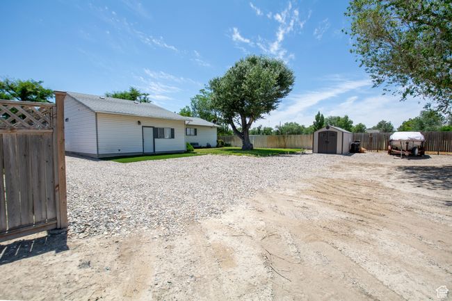 Fenced backyard with a storage shed | Image 8
