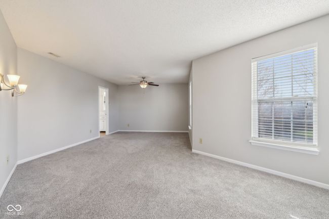 empty room featuring carpet flooring, baseboards, and a chandelier | Image 36