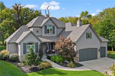 View of front facade with a garage and a front lawn | Image 2