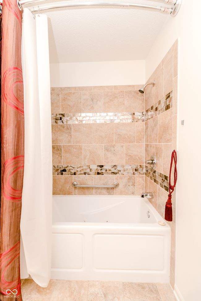bathroom with shower / bathtub combination with curtain | Image 21