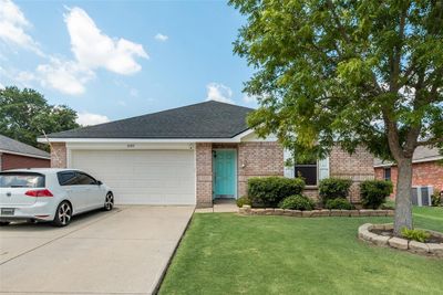 Ranch-style house with a front lawn, a garage, and central AC | Image 1