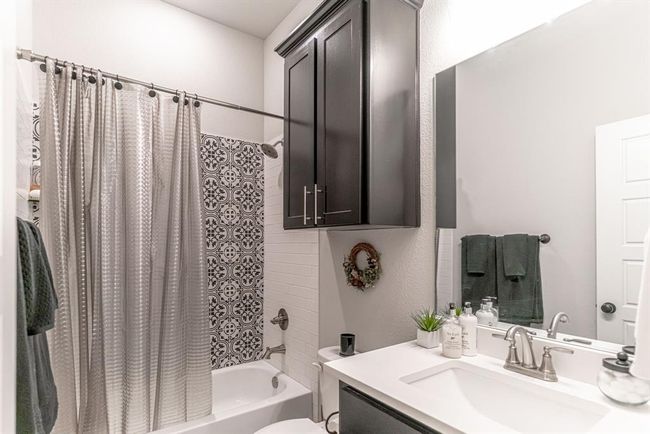 Bathroom with tile floors, toilet, and dual bowl vanity | Image 28