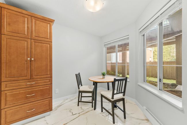 Dining room with marble finish floor, plenty of natural light, and baseboards | Image 11