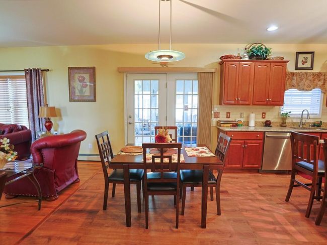 Dining space with recessed lighting, a healthy amount of sunlight, a baseboard heating unit, and light wood finished floors | Image 11