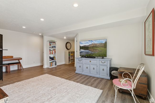 Living area featuring light wood-style floors and recessed lighting | Image 25