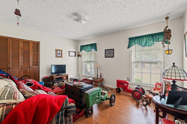 Living room with plenty of natural light, wood finished floors, and a textured ceiling | Image 19