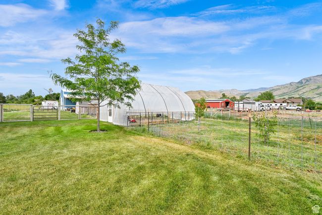 View of yard featuring an outbuilding and a mountain view | Image 61