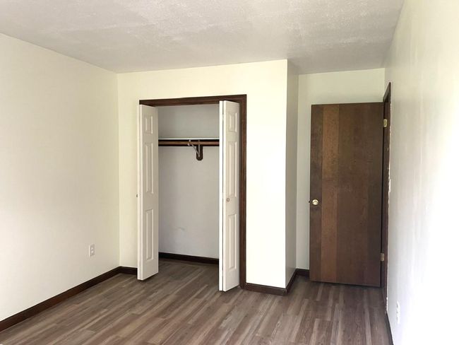 Unfurnished bedroom featuring wood finished floors and a closet | Image 14