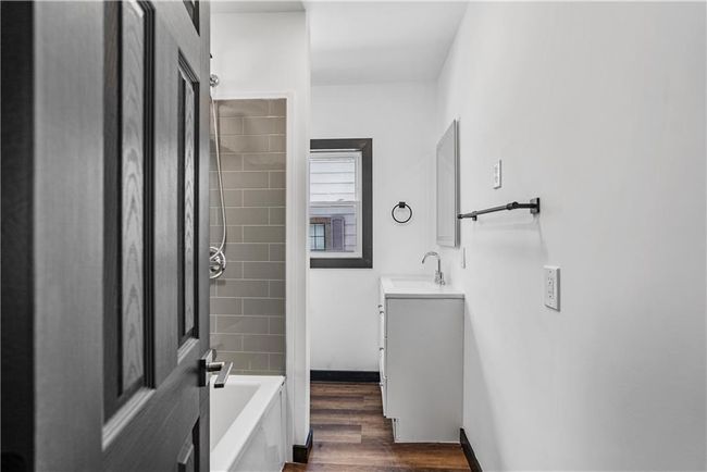 Full bath featuring vanity, bathtub / shower combination, and wood finished floors | Image 30