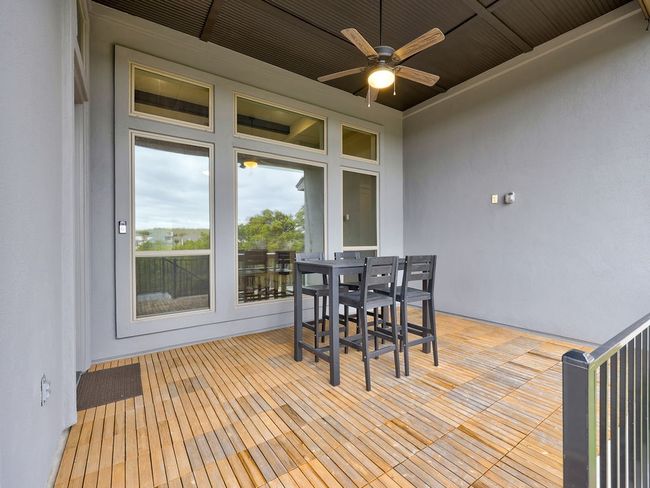 Private covered patio with ceiling fan and stairs to bacyard | Image 36