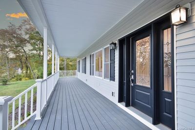 Deck at dusk featuring a porch | Image 2