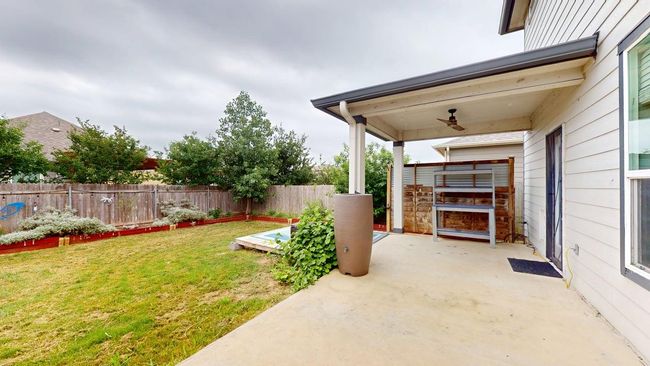 View of yard featuring a patio, a ceiling fan, and fence | Image 35