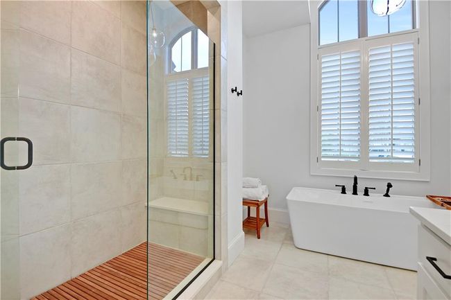 Bathroom with plenty of natural light, a freestanding tub, tile patterned flooring, and a stall shower | Image 35