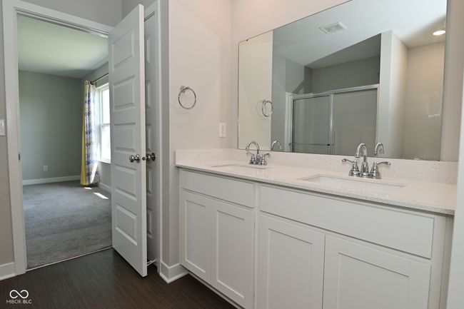 full bathroom with an enclosed shower, visible vents, baseboards, and a sink | Image 43