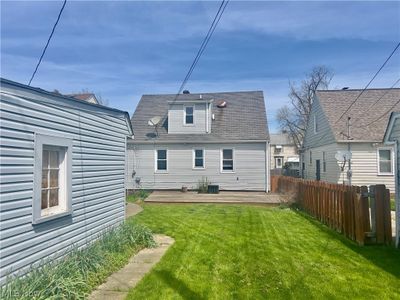 Rear view of property featuring a wooden deck and a lawn | Image 3