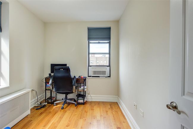 Office with radiator, cooling unit, wood finished floors, and baseboards | Image 12