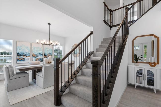 Staircase with a healthy amount of sunlight, an inviting chandelier, and hardwood / wood-style floors | Image 18
