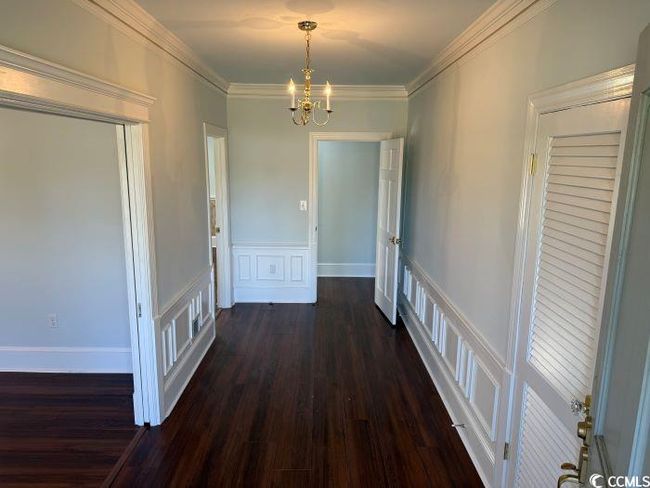 Corridor featuring ornamental molding, a notable chandelier, and dark hardwood / wood-style floors | Image 10