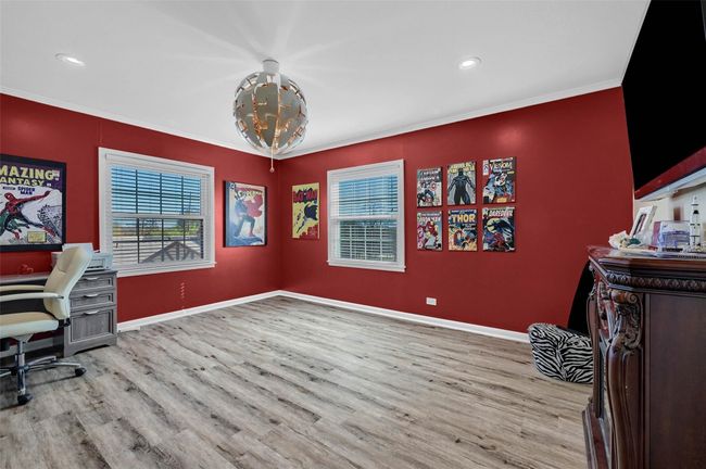 Home office featuring wood finished floors, baseboards, recessed lighting, crown molding, and a chandelier | Image 31