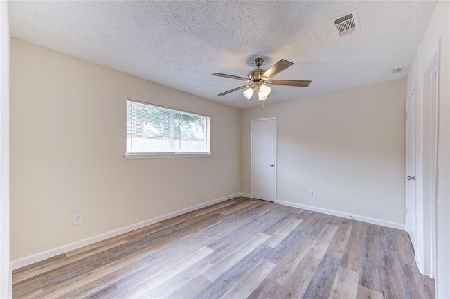 Primary Bedroom. All bedrooms have blinds and new ceiling fans. The primary bedroom has a walk-in closet and ensuite bathroom! | Image 16