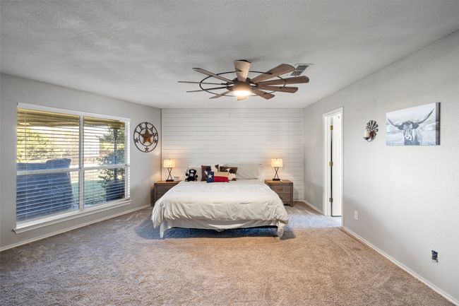 Bedroom with baseboards, a ceiling fan, carpet flooring, and a textured ceiling | Image 14