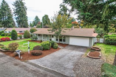 Beautifully landscaped with grassy yard, raised flower beds, paved walkways, ample off-street parking & quality paint job | Image 3