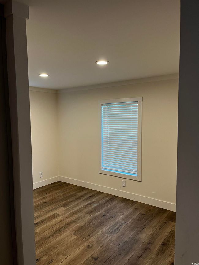 Unfurnished room featuring dark wood-style flooring, recessed lighting, and ornamental molding | Image 8