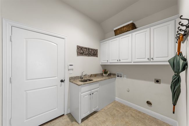 Yes this home has a separate laundry room with sink a good size for extra storage! | Image 29
