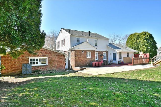 Rear view of property with a lawn, a patio, and brick siding | Image 5