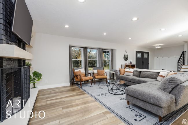 Living area featuring recessed lighting, a premium fireplace, and light wood-type flooring | Image 8