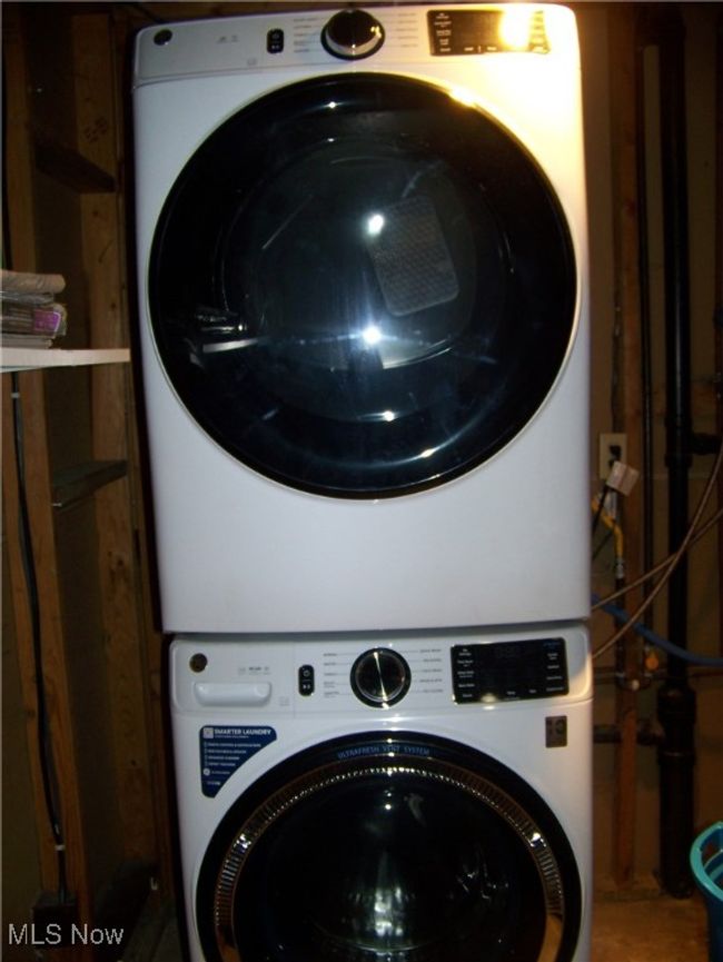 Laundry room featuring stacked washer / drying machine | Image 6